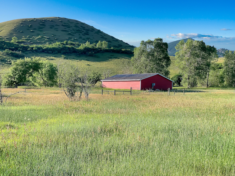barn with mountains in background